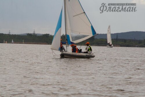 Яхта Вильсон на фоне берега и яхт